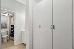 Bathroom with tile patterned floors, toilet, curtained shower, and vanity