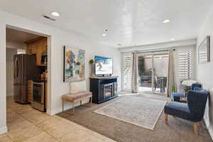 Living room featuring a textured ceiling and light tile patterned floors