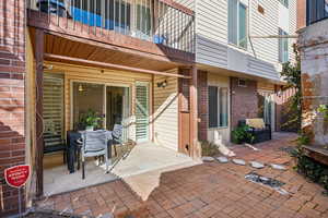 View of patio with a balcony