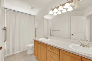 Bathroom with tile patterned flooring, vanity, and toilet