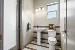 Bathroom featuring tile patterned floors and toilet