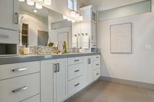 Bathroom with vanity and decorative backsplash