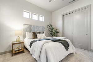 Bedroom with carpet floors, ceiling fan, and a closet