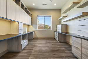 Kitchen featuring built in desk and dark hardwood / wood-style flooring