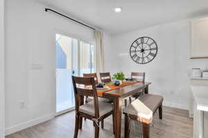 Dining space with light hardwood / wood-style floors