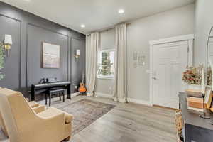 Foyer entrance with light wood-type flooring