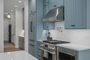 Kitchen with professional grade stainless steel appliances, pot filler, bill 10 bottom amount refrigerator, and backsplash