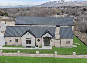 View of front facade with a mountain view and a front lawn