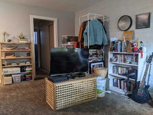 Interior space featuring dark colored carpet