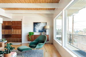 Sitting room with beamed ceiling, light hardwood / wood-style floors, and wooden ceiling