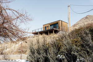 Rear view of house featuring a mountain view