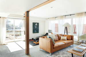 Carpeted living room featuring a textured ceiling