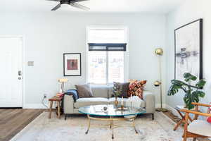 Living room featuring hardwood / wood-style flooring and ceiling fan