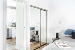 Bedroom with a closet and light hardwood / wood-style flooring