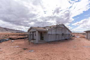 Back of house featuring a mountain view and a patio