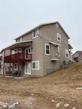 Rear view of house featuring a patio area and a lawn