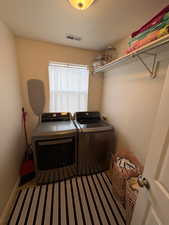 Washroom with washer and clothes dryer