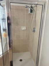 Bathroom featuring a shower with door