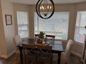 Dining room featuring an inviting chandelier and dark hardwood / wood-style floors