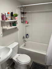 Full bathroom featuring shower / tub combo, sink, and toilet