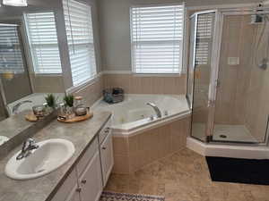 Bathroom with vanity and plus walk in shower