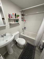 Bathroom featuring toilet and shower / tub combo