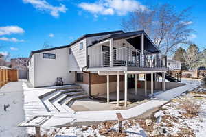 View of snow covered back of property