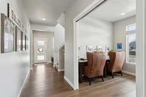 Interior space with wood-type flooring and a textured ceiling