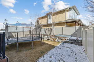 Back of property with a trampoline