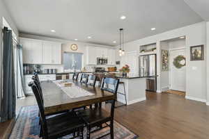 Dining space with sink, a textured ceiling, and dark hardwood / wood-style flooring