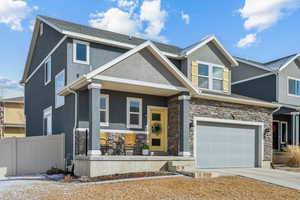 View of front facade featuring a garage and covered porch