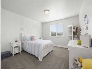 Bedroom featuring light colored carpet