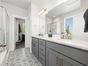 Bathroom featuring vanity and a shower with shower door