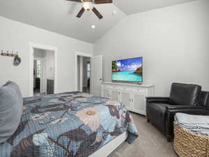 Bedroom with ceiling fan, lofted ceiling, and carpet flooring