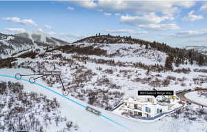 Snowy aerial view featuring a mountain view