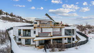 Snow covered house with a mountain view