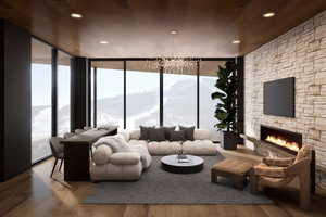 Living room with hardwood / wood-style flooring, floor to ceiling windows, a stone fireplace, and plenty of natural light