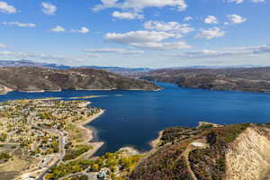 Birds eye view of property featuring a water and mountain view