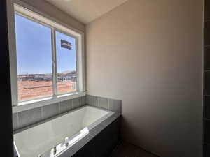 Full bath featuring tile patterned floors and a garden tub