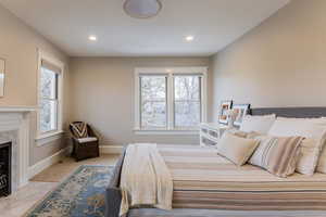 Bedroom with a tile fireplace