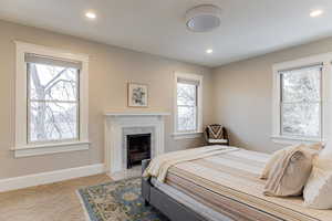 Bedroom featuring a fireplace