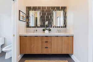 Bathroom featuring tasteful backsplash, tile patterned floors, and a bidet