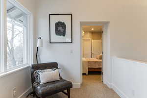 Sitting room featuring light carpet