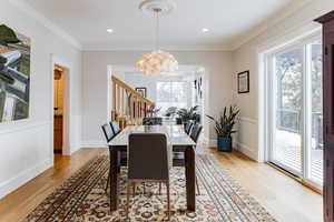 Dining room featuring crown molding, a chandelier, and light wood-type flooring