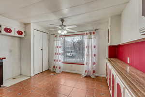 Interior space featuring white cabinetry and ceiling fan