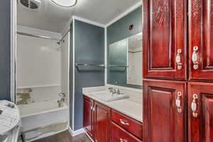 Bathroom featuring vanity, hardwood / wood-style floors, washer / dryer, and washtub / shower combination