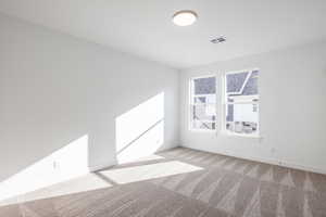 Unfurnished room with light colored carpet