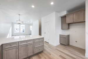 Kitchen featuring decorative light fixtures, light hardwood / wood-style floors, and a chandelier