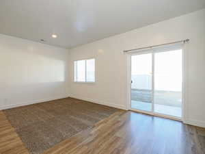 Empty room with hardwood / wood-style flooring