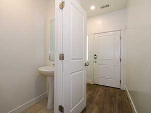 Hallway with dark wood-type flooring